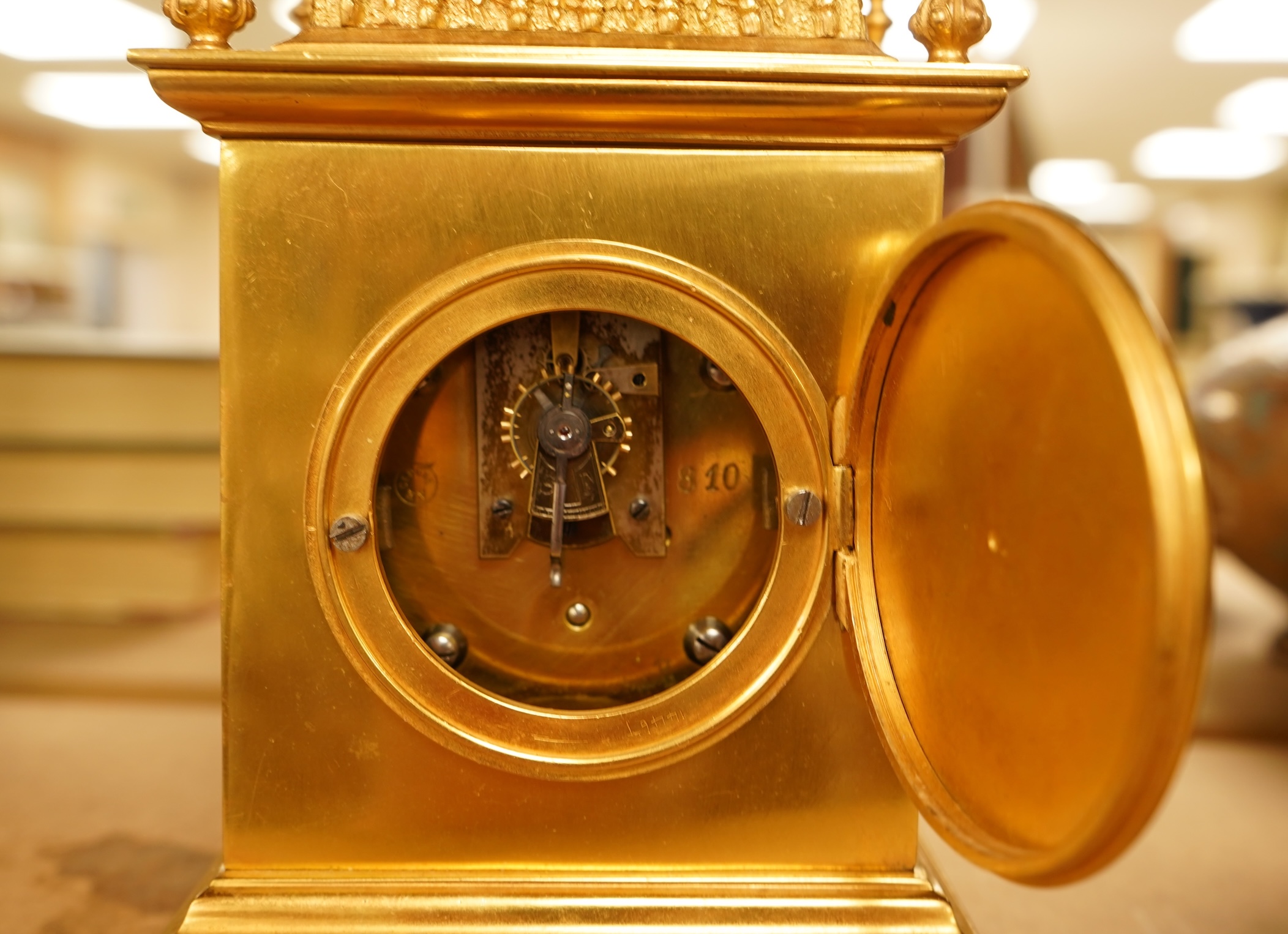 A French gilt brass timepiece with key, 19cm high